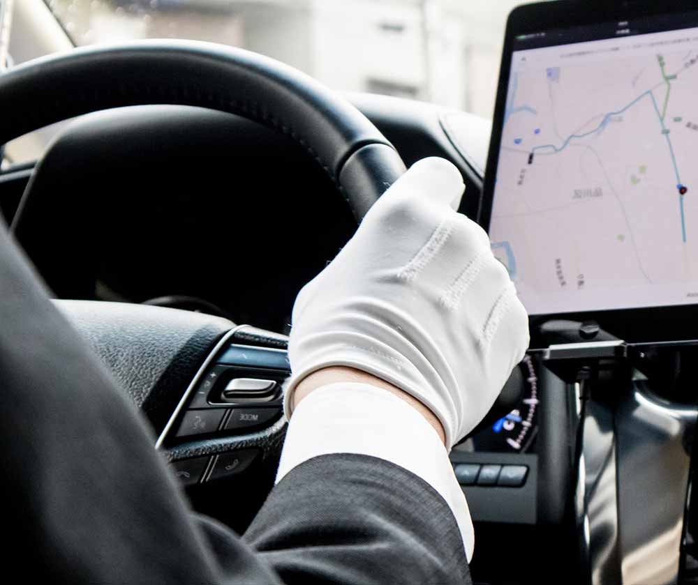 Driver with white gloves on